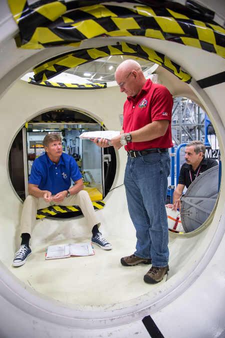 NASA astronaut Scott Kelly (center), Russian cosmonaut Mikhail Kornienko (right), and Russian cosmonaut Gennady Padalka, participate in an emergency scenario training session in an International Space Station mock-up/trainer in the Space Vehicle Mock-up Facility at NASA's Johnson Space Center. Image Credit: NASA. nasascotkelly