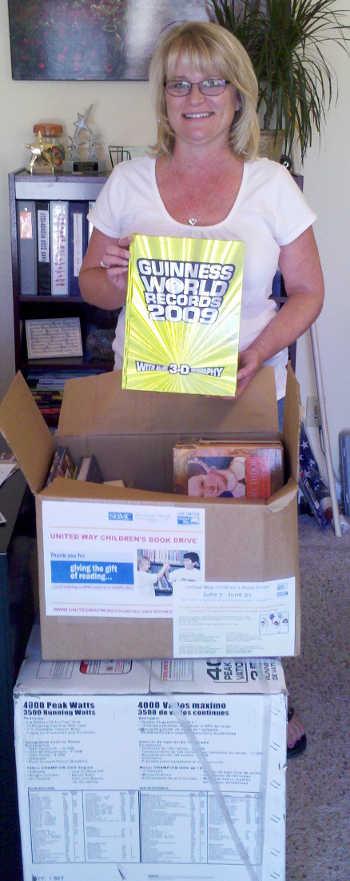 Lisa Fronsman from the Lake County Family Resource Center in Kelseyville, Calif., with the books collected by Calpine. Courtesy photo. lisafronsmanbooks