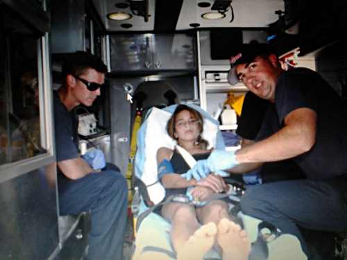 Serena Mcevoy, 11, of Middletown, Calif., was attacked by a pit bull on Tuesday, August 13, 2013. Here she's shown being transported by South Lake County Fire Protection District ambulance to St. Helena Hospital Clear Lake in Clearlake, Calif. Photo courtesy of Jon Henry, published with consent of the girl's mother, Ronni Berg. 081313pitbullattack