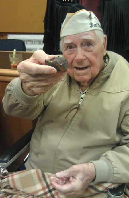 On Friday, Dec. 7, 2012, Henry “Andy” Anderson of Lakeport, Calif., shows a piece of shrapnel from a Japanese bomb that hit the turret of his ship the USS Tennessee on Sunday, December 7, 1941, during the attack on Pearl Harbor, Hawaii. The shrapnel went right through the seat where Anderson would have been sitting for breakfast had he not been on errands that morning. Anderson said the sharp chunk of metal was enough to kill someone, “or at least give ‘em a headache.” Anderson died on Monday, January 6, 2014, at the age of 95. Photo by Elizabeth Larson. 120712andersonschrapnel
