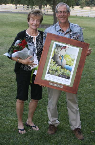 Lake County Farm Bureau President Dave Rosenthal presenting Annette Hopkins with the Lake County Farm Bureau Agriculture Appreciation Award at the 91st annual meeting and dinner on Wednesday, July 16, 2014, in Lakeport, Calif. Photo courtesy of Lake County Farm Bureau. 071614lcfbhopkins