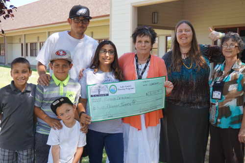 From left, the Carmichael family – Miranda and Chris, and sons Edward, Quentin and Christian – and Lake County Social Services Department staff Annette Adkins, Jill Wicks and a department office assistant. Photo by Shari Shepard/Lake County News. aug2015ssfssprogram