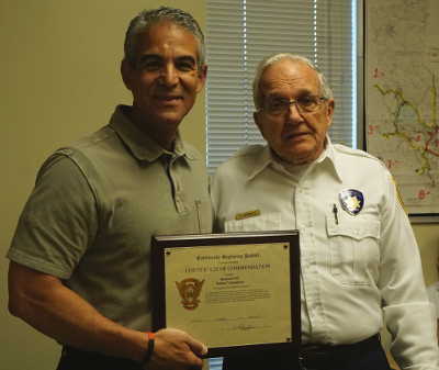 From left, Lt. Hector Paredes, commander of the Clear Lake Area office of the California Highway Patrol in Kelseyville, Calif., presents a certificate of commendation to Ed McDonald, president of the local CHP office’s senior volunteers, at a special luncheon on Wednesday, April 19, 2017. Photo by Elizabeth Larson/Lake County News. 041917chpvolunteersmcdonald