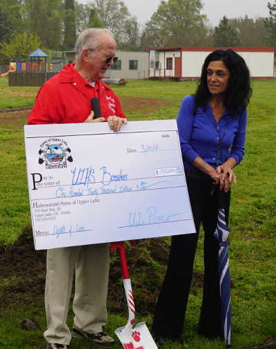 Ron Raetz, leader of the project to raise funds for stadium lighting at Upper Lake High School in Upper Lake, Calif., receives a check for $130,000 from Habematolel Pomo of Upper Lake Tribal Chair Sherry Treppa on Monday, April 24, 2017. Photo by Elizabeth Larson/Lake County News. 042417ulhslightscheck