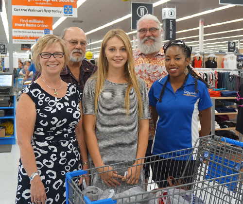 From left, Konocti Unified School District Superintendent Donna Becnel, Rotarian Russ Cremer, Lower Lake High School student Jolene Scarborough, Rotarian Dirk Slooten and Bilalia Mubashshir, Konocti Unified's youth services coordinator, at a gift card giveaway at the Walmart store in Clearlake, Calif., on Wednesday, August 24, 2016, for children whose families lost their homes in the Clayton fire. Scarborough is pictured with a basket of items she was able to pick up for school thanks to the gift card she received. Photo by Elizabeth Larson/Lake County News. 082416brownwalmartgroup2