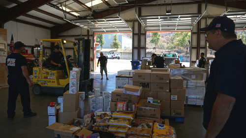 Lake County Fire Protection District Chief Willie Sapeta, right, oversees the reorganizing of supplies for Clayton fire survivors at Station 65 in Lower Lake, Calif., on Sunday, August 28, 2016. Photo by Elizabeth Larson/Lake County News. 082816lakecofirechief