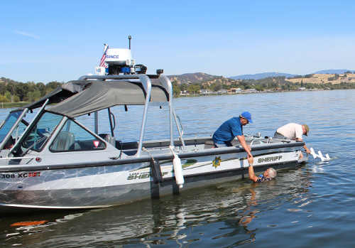 Lake County Sheriff's Marine Patrol deputies pulled the pilot of a Grumman Widgeon seaplane into their boat on Saturday, September 17, 2016, in Lakeport, Calif. The pilot's plane crashed into the water as he was attempting to land. Photo by Damon Trimble. 091716seaplanecrashtrimble2