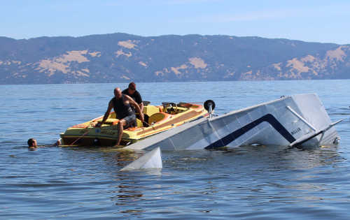 Rescuers helped pull two men from a Grumman Widgeon seaplane that crashed into Clear Lake near Lakeport, Calif., on September 17, 2016, in Lakeport, Calif. The man seen in the water here was part of the rescue effort. Photo by Damon Trimble. 091716seaplanecrashtrimble4
