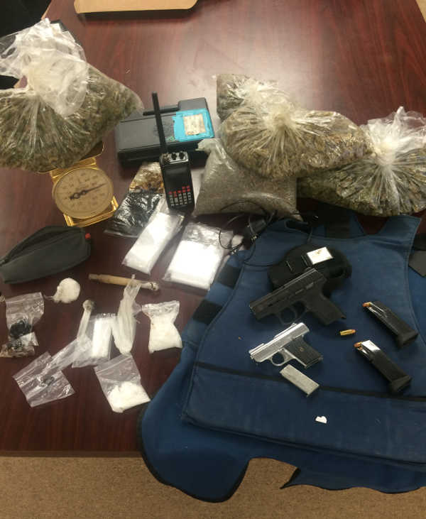 Search warrant service leads to two arrests, seizure of drugs and weapons
