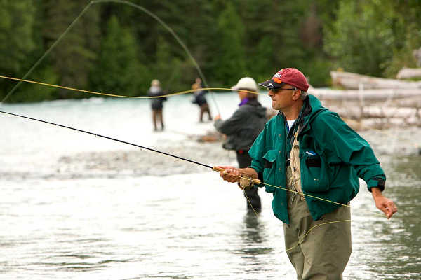Fly fishermen. US Fish and Wildlife photo. California Outdoors: Bringing home fish caught out of state, no deer tag, measuring salmon correctly
