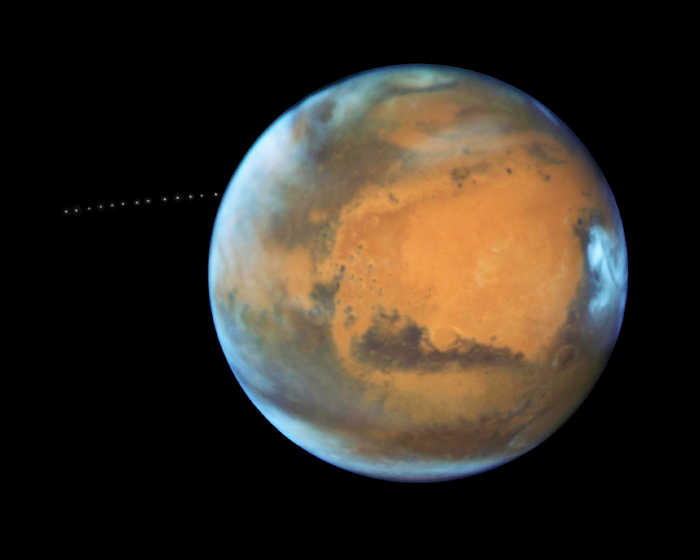 Over the course of 22 minutes, Hubble took 13 separate exposures, allowing astronomers to create a time-lapse image showing the tiny moon Phobos during its orbital trek (white dots) around Mars. This image is a composite of separate exposures acquired by NASA's Hubble WFC3/UVIS instrument. Banner Animation: The animation at the top of the page was made from these images. Credits: NASA, ESA, and Z. Levay (STScI), Acknowledgment: J. Bell (ASU) and M. Wolff (Space Science Institute). Space News: NASA’s Hubble sees Martian moon orbiting the Red Planet
